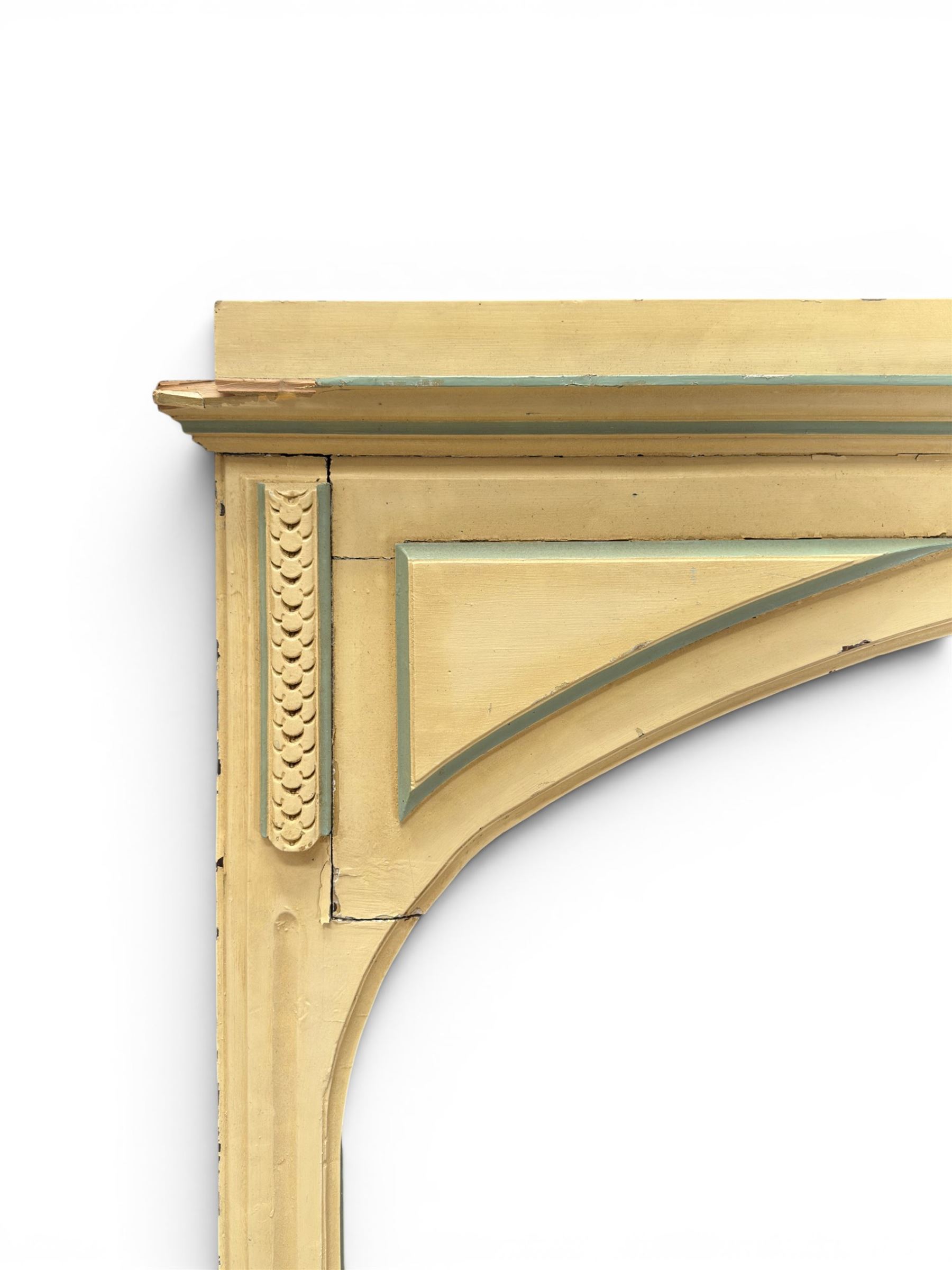 Two large painted pine window or door surrounds, square cornice with arch top, applied mouldings (widths 180cm and 130cm)