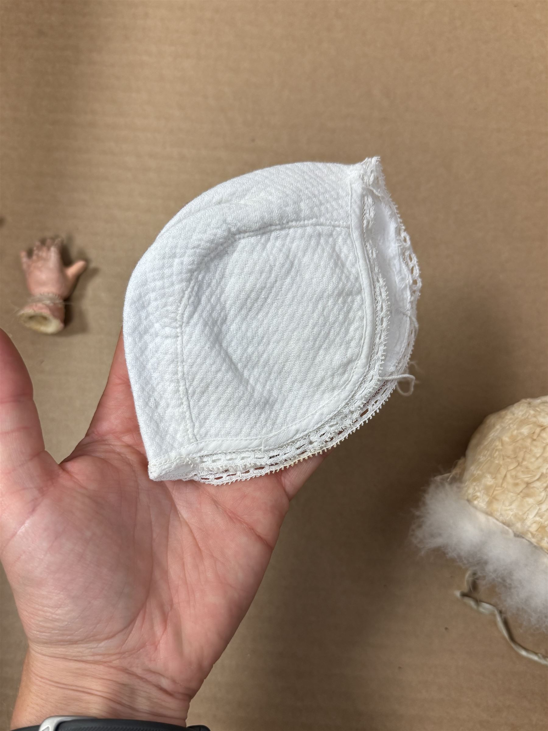 Two German bisque head dolls, to include a Franz Schmidt example with blue glass eyes and an Armand Marseille 590 example with applied hair, together with a Schoenau & Hoffmeister bisque doll's head, pair of doll's hands and a collection of clothing