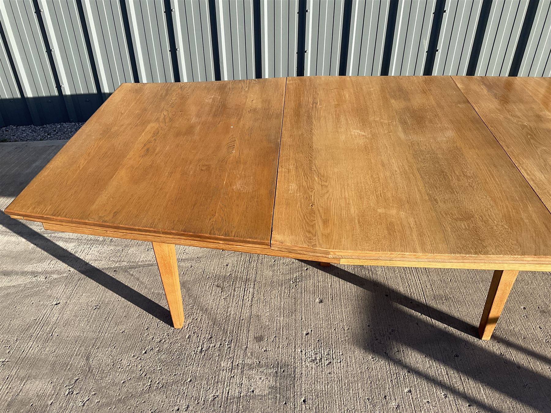 Light oak bespoke boardroom table, concave form, four sectional top on square discreet legs (12' x 5'), with twelve armchairs including 'Chairmans' chair