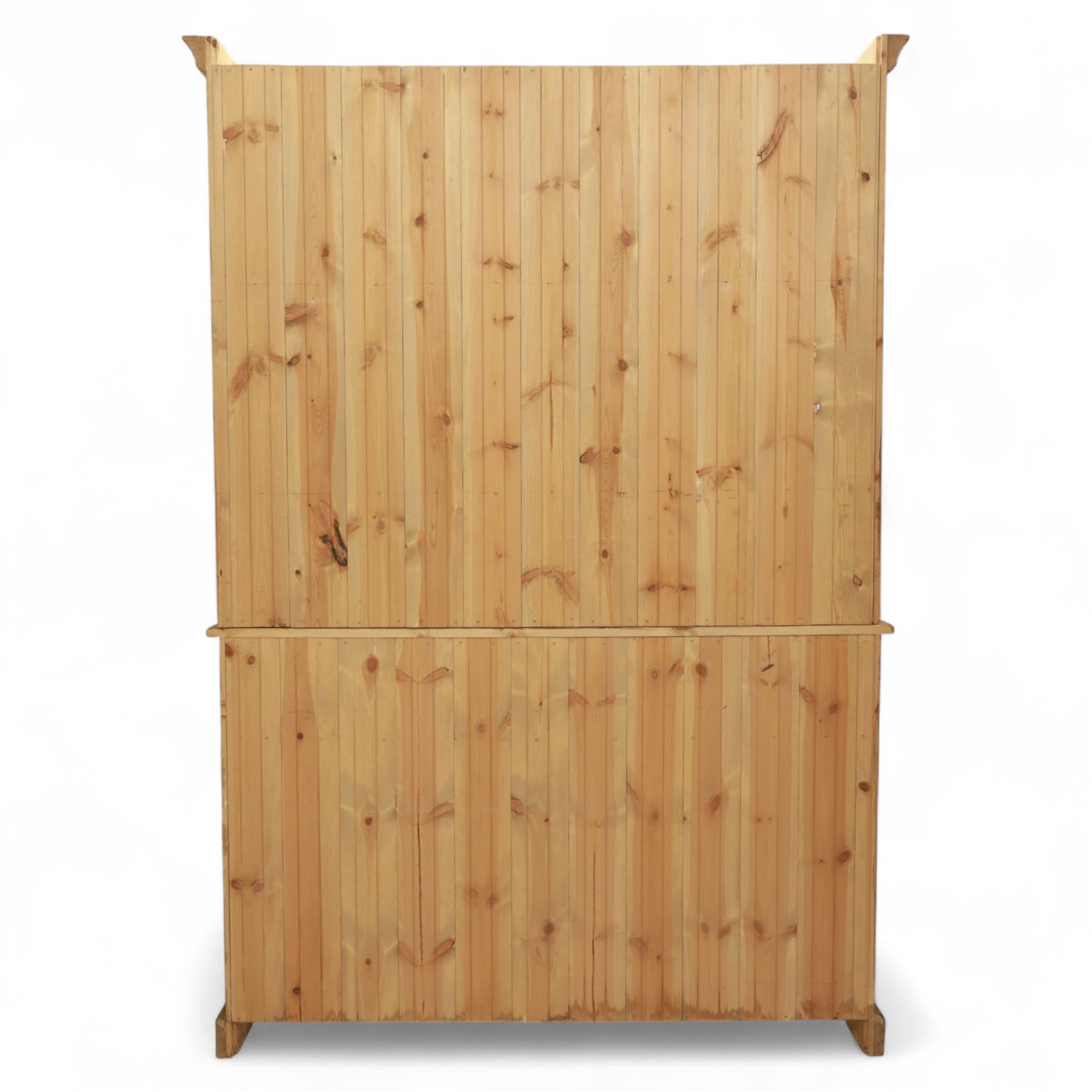 Late 20th century pine kitchen dresser, the upper section with open shelves and tongue and groove back, over a triple cupboard base with three drawers, turned wooden knobs throughout