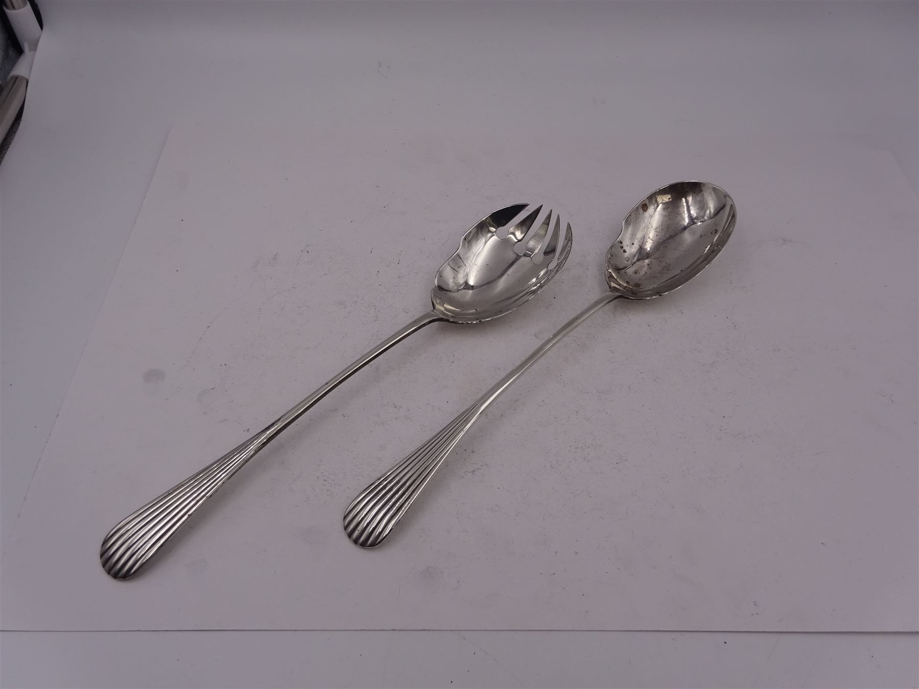 Pair of early 20th century silver salad servers, both with shaped bowls and fluted handles, hallmarked James Dixon & Sons Ltd, Sheffield 1918