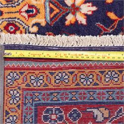 North West Persian carpet, the indigo field centred by a lobed medallion in pale blue and ochre with floral pendants, profusely decorated with scrolling foliage, palmettes and flowerheads, ivory floral spandrels, enclosed by a red ground palmette border and multiple floral guard bands
