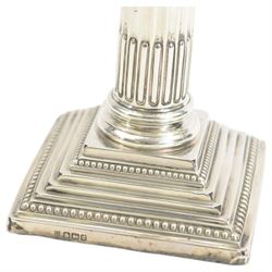 Pair of early 20th century silver Corinthian column candlesticks, upon square stepped filled bases, hallmarked Walter Latham & Son, Sheffield 1913, H16cm