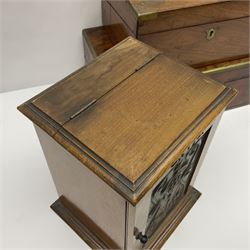 Early 20th century oak correspondence box, with black silver plated shield cartouche to cover, opening to reveal letter rack, glass inkwell and pen holder, together with two brass bound writing slopes and an Edwardian smokers cabinet with embossed metal panel to door, tallest H29cm