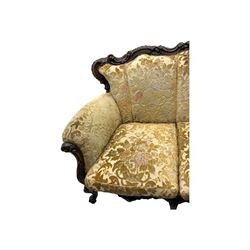 Victorian design stained wood three seater settee, top rail carved and scrolled, padded back and arms, scrolled cabriole feet 