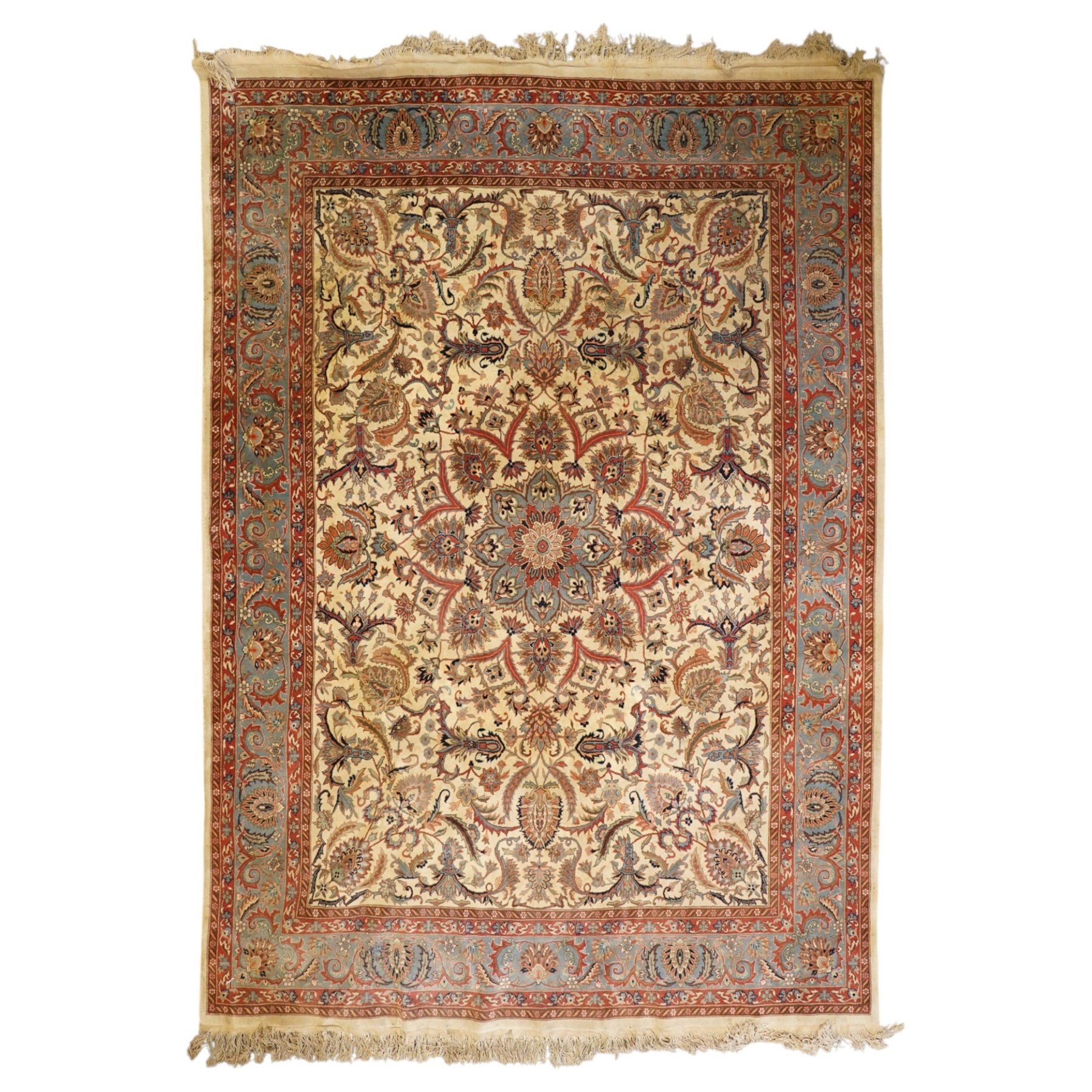 Persian Isfahan ivory and crimson ground rug, the busy field with central floral pole medallion surrounded by foliate motifs and stylised palmettes, the indigo guard line with repeating scrolling plant motifs