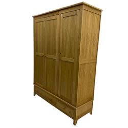 Corndell Furniture - light oak triple wardrobe, enclosed by three panelled doors, one long and one short drawer