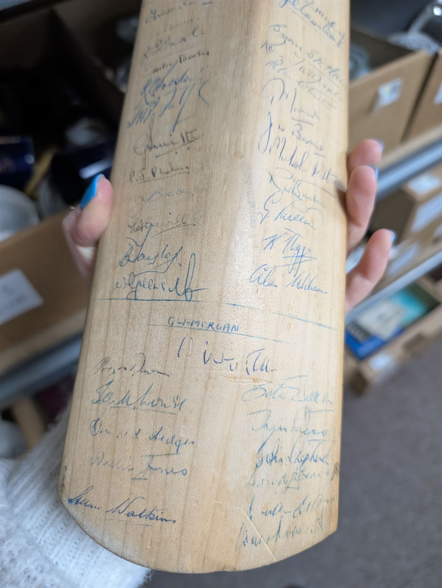 Two signed cricket bats, with signatures including Colin Cowdrey