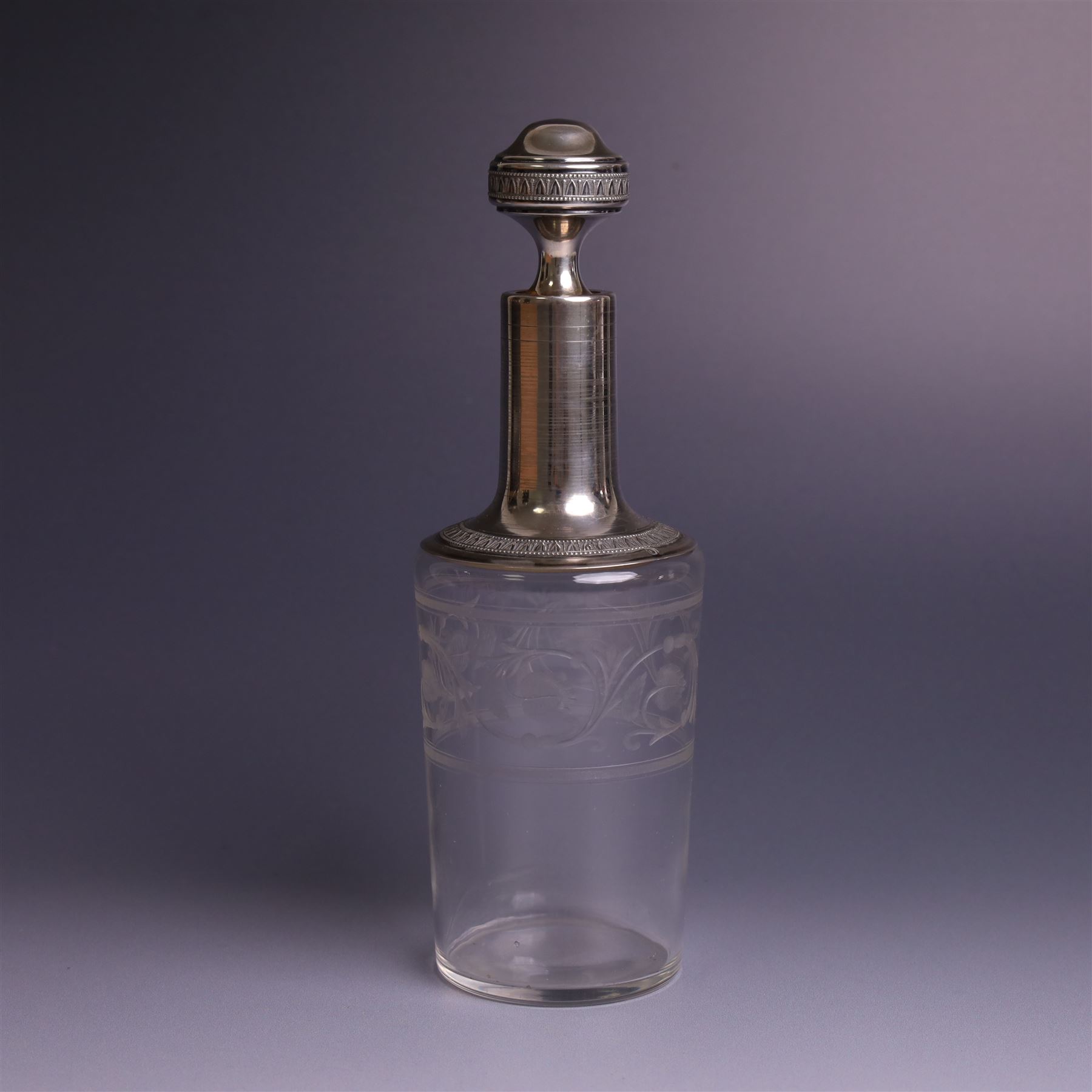 French silver mounted glass decanter and shot glass set, the decanter with silver covered stopper, removable silver collar, and etched decoration to glass body, the six silver mounted glasses each with etched decoration, silver stamped with Minerva's head, decanter H 21cm