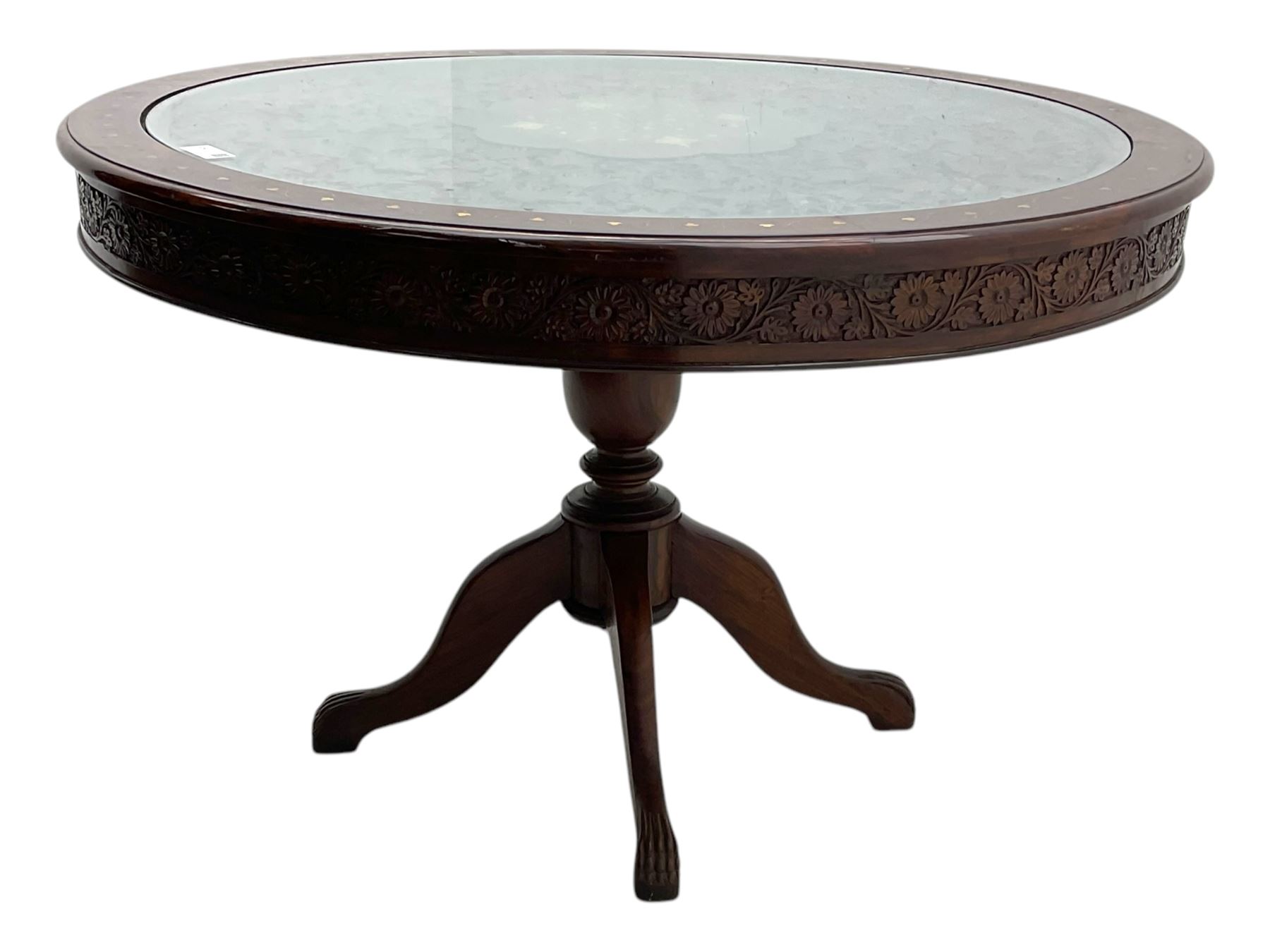 Pakistan carved hardwood brass inlaid circular dining table, and four rail back chairs with saddle seats