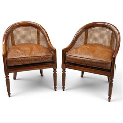 Laura Ashley - pair of bergère tub armchairs with leather seats, raised on fluted and turn...