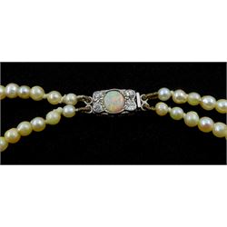 Double strand pearl necklace, graduating pearls between 3mm and 7.5mm, on 18ct white gold old cut diamond and opal milgrain set clasp, boxed
