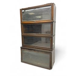 Globe Wernicke - early 20th century oak four-tier stacking library bookcase, four glazed sections enclosed by hinged and sliding doors