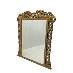 Large ornate gilt framed mirror, the pediment with central cartouche with extending pierced and moulded scroll work and acanthus leaves