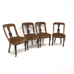 Set of four Late Victorian walnut dining chairs, carved decoration to the top rail and stiles, turned legs with a fluted detail and upholstered seats, W52cm 