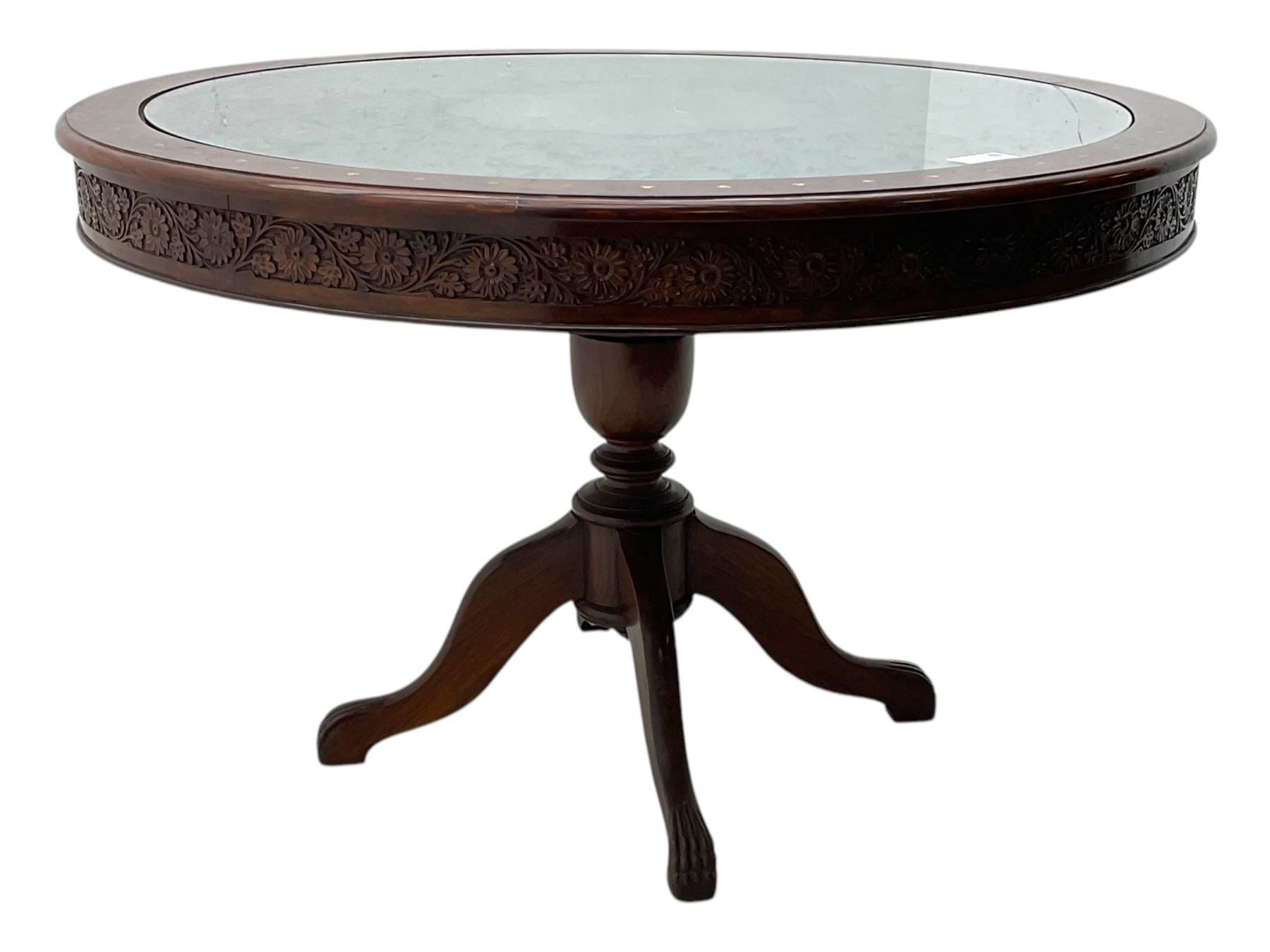 Pakistan carved hardwood brass inlaid circular dining table, and four rail back chairs with saddle seats