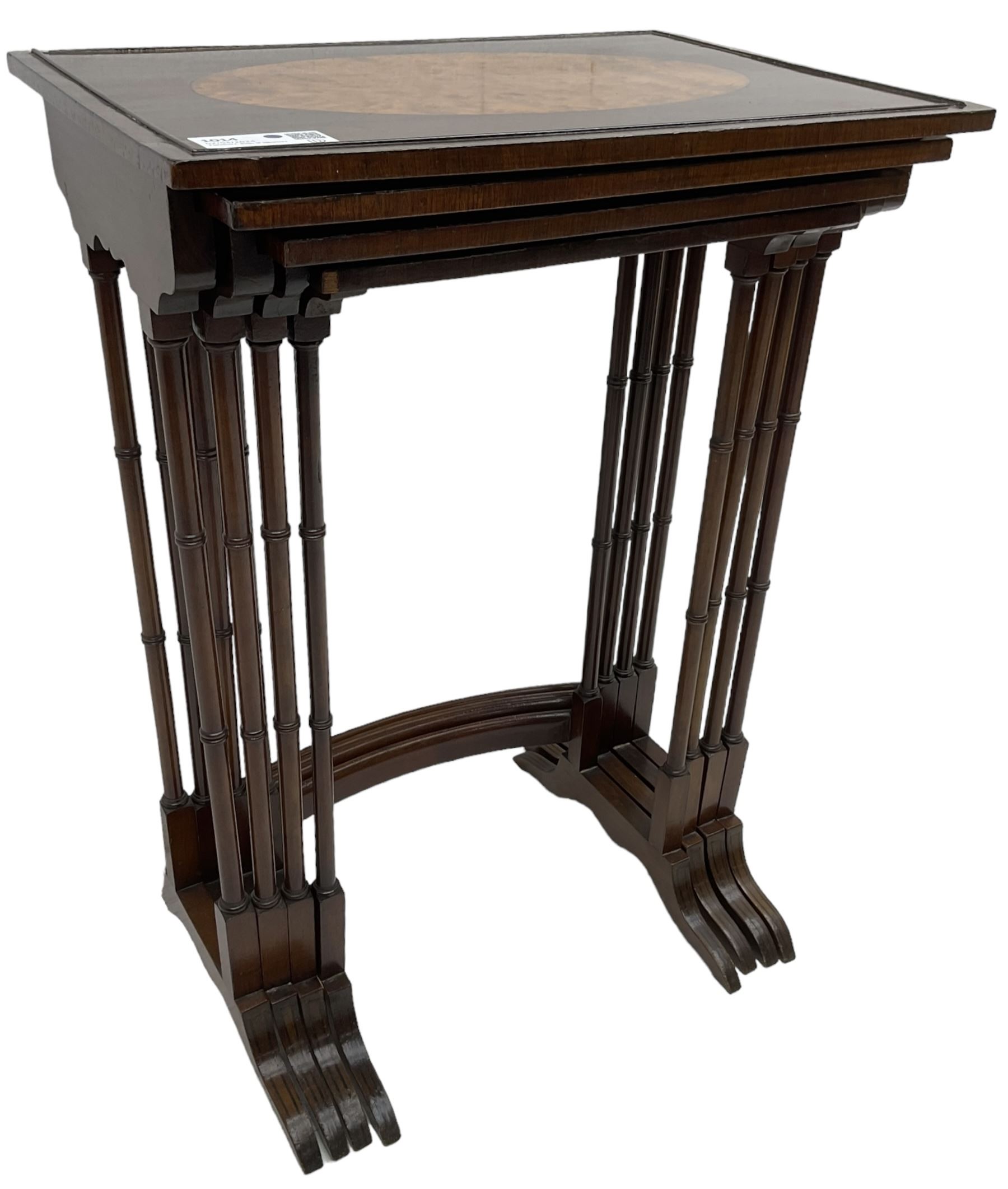 20th century inlaid mahogany quartetto nest of four tables, rectangular top inlaid with birdseye maple oval panel, ring turned supports on sledge feet