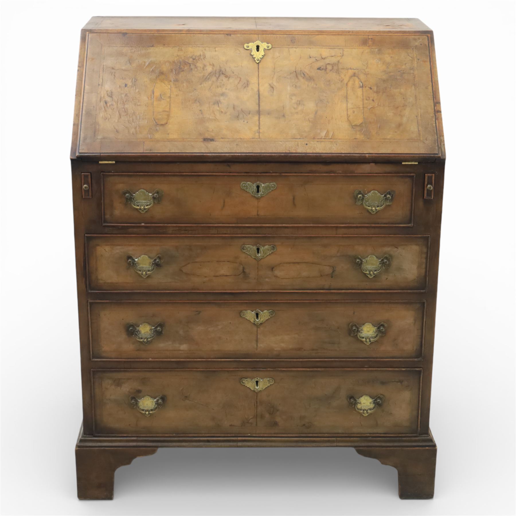 19th century walnut bureau of small proportions, the sloping fall enclosing a fitted interior with shaped pigeonholes and small drawers, above four long graduated drawers with feather banded walnut veneers, fitted with brass swan neck handles and escutcheons, raised on shaped bracket feet