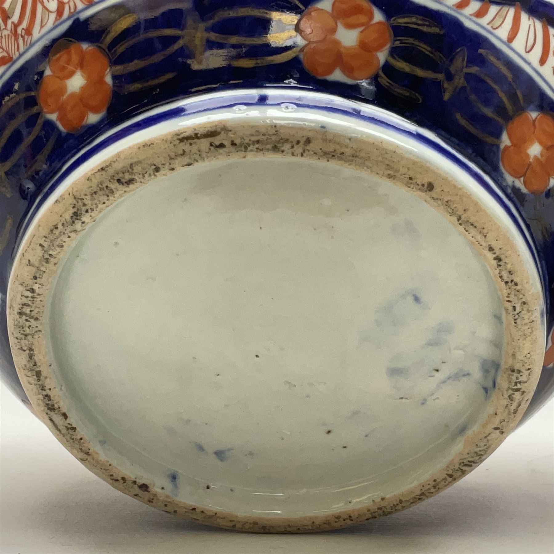 Pair of large 19th century Japanese Imari porcelain bottle vases, painted with shaped reserves of peonies, chrysanthemums and prunus blossom, each H46cm