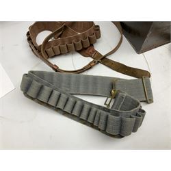 Assorted militaria including ten leather or canvas cartridge and other belts, maroon beret with 17th Lancers cap badge, modern bullet mould, leather and brass shot flask, two knives, shell cases, boomerang etc; in tin deed box