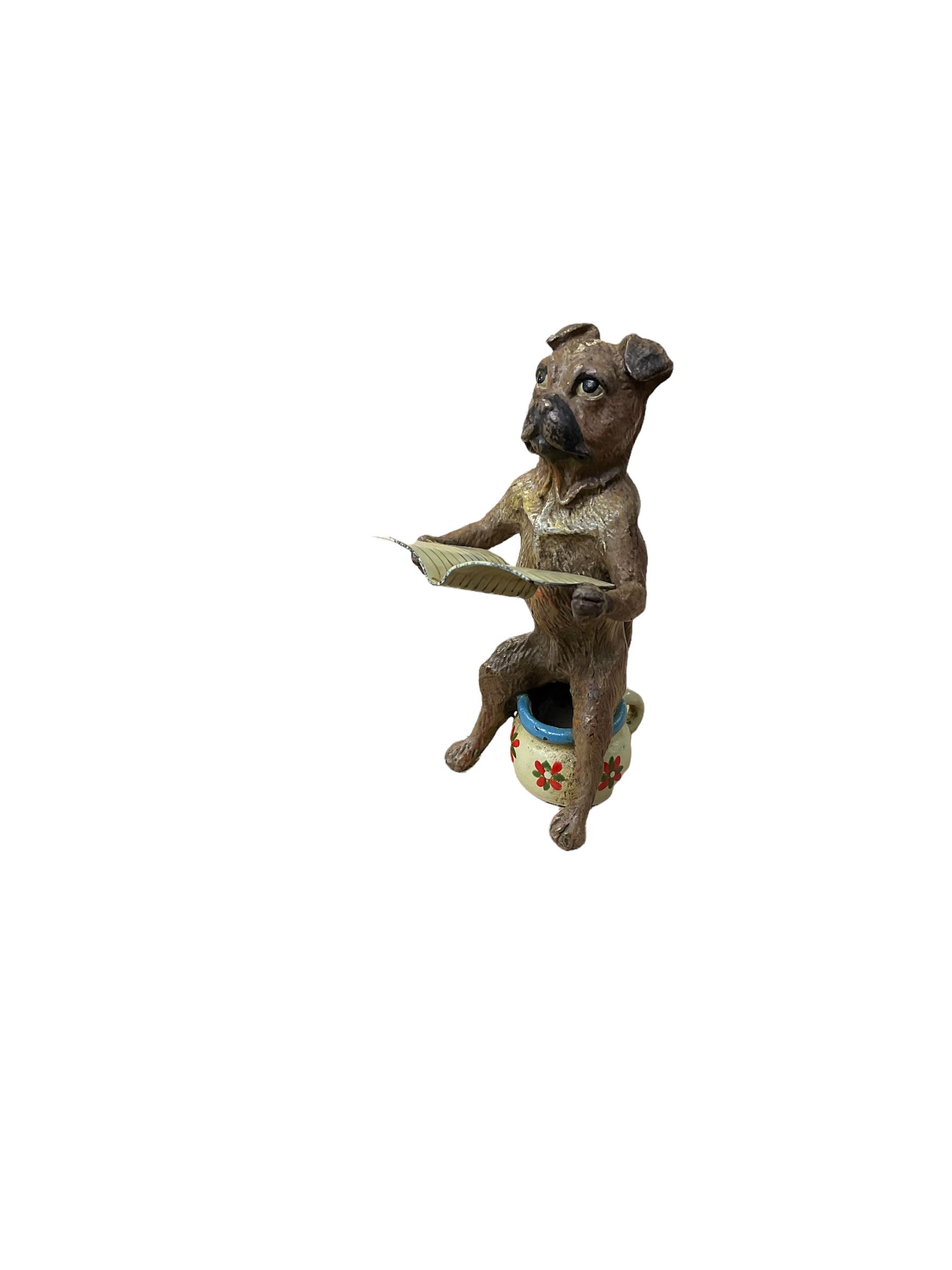 After Franz Bergmann (1861-1936): Austrian cold painted bronze figure of a pug dog reading a book, sitting on a chamber pot, with Bergmann type mark beneath H8cm
