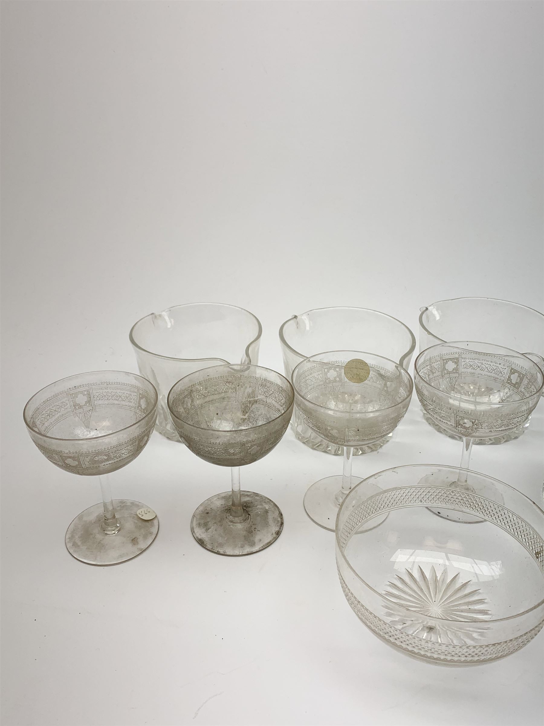 Seven 19th century and later double lip glass rinsers of various design, together with a pair of Edwardian cut glass finger bowls, and four Edwardian champagne glasses with engraved decoration. 