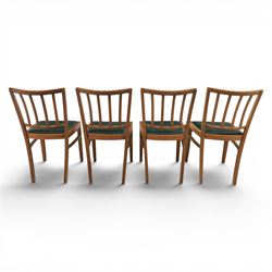 Mid 20th century teak extending dining table, together with eight teak chairs with green leather seats, extends to 154cm