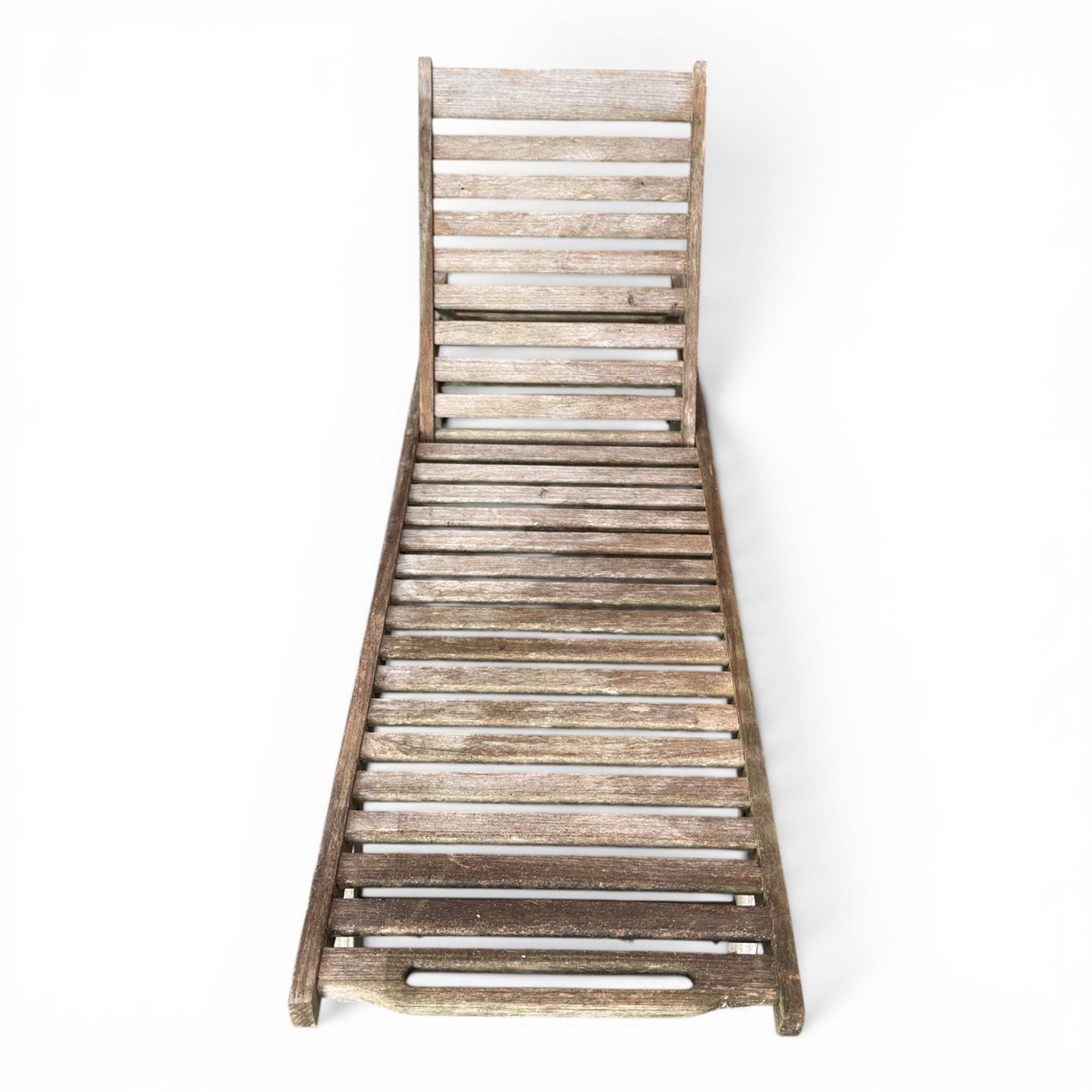 Pair of teak garden sun loungers, with slatted adjustable backrests, integrated wheels and sliding pull-out side trays, weathered natural finish.