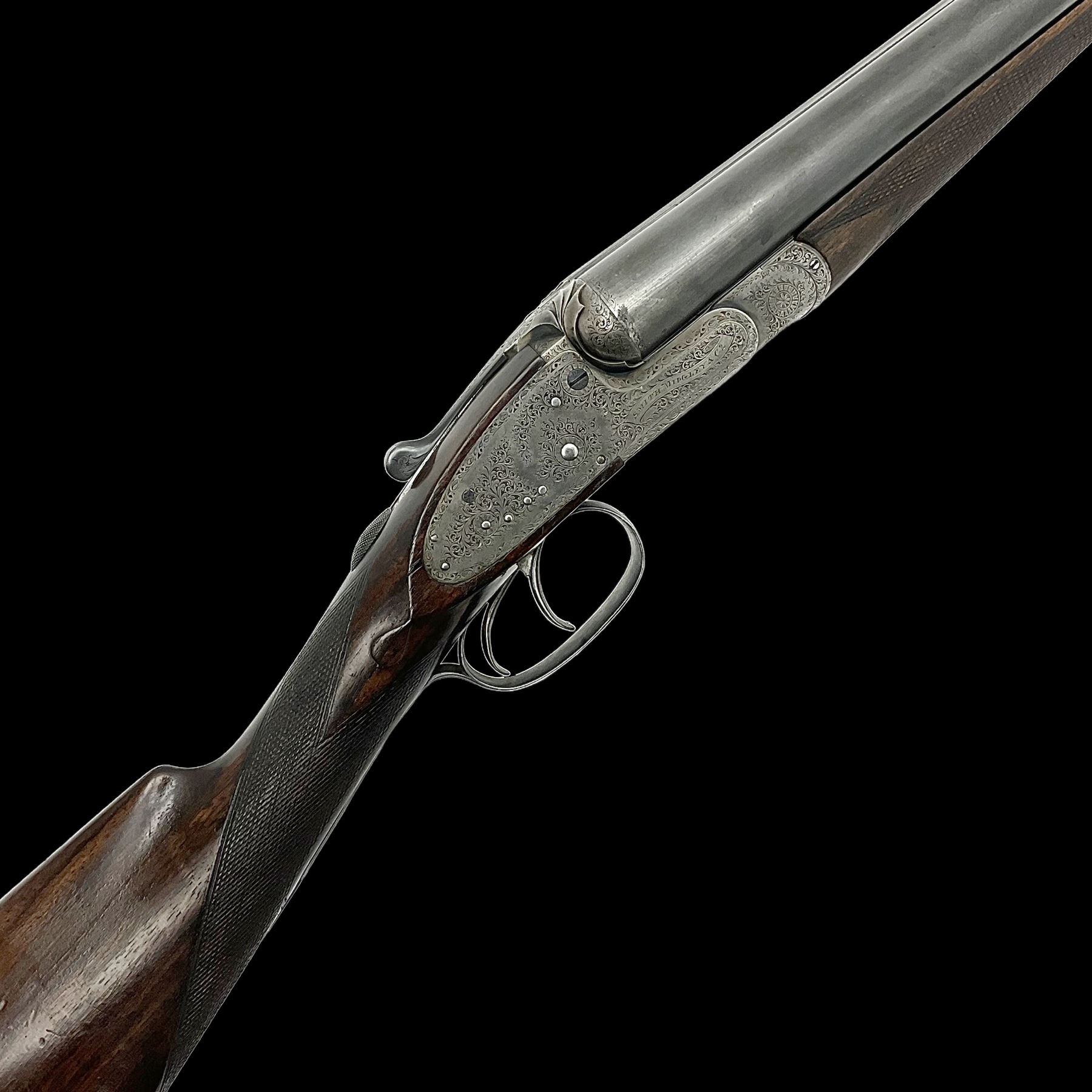 Smith Midgley Bradford 12-bore side-by-side double barrel side-lock ejector shotgun with 71cm barrels, engraved action with patented top lever, ivy leaf fences and top safety, walnut stock with chequered grip and fore-end, serial no.62409 to barrels and 1481 to action, L115cm overall SHOTGUN CERTIFICATE REQUIRED