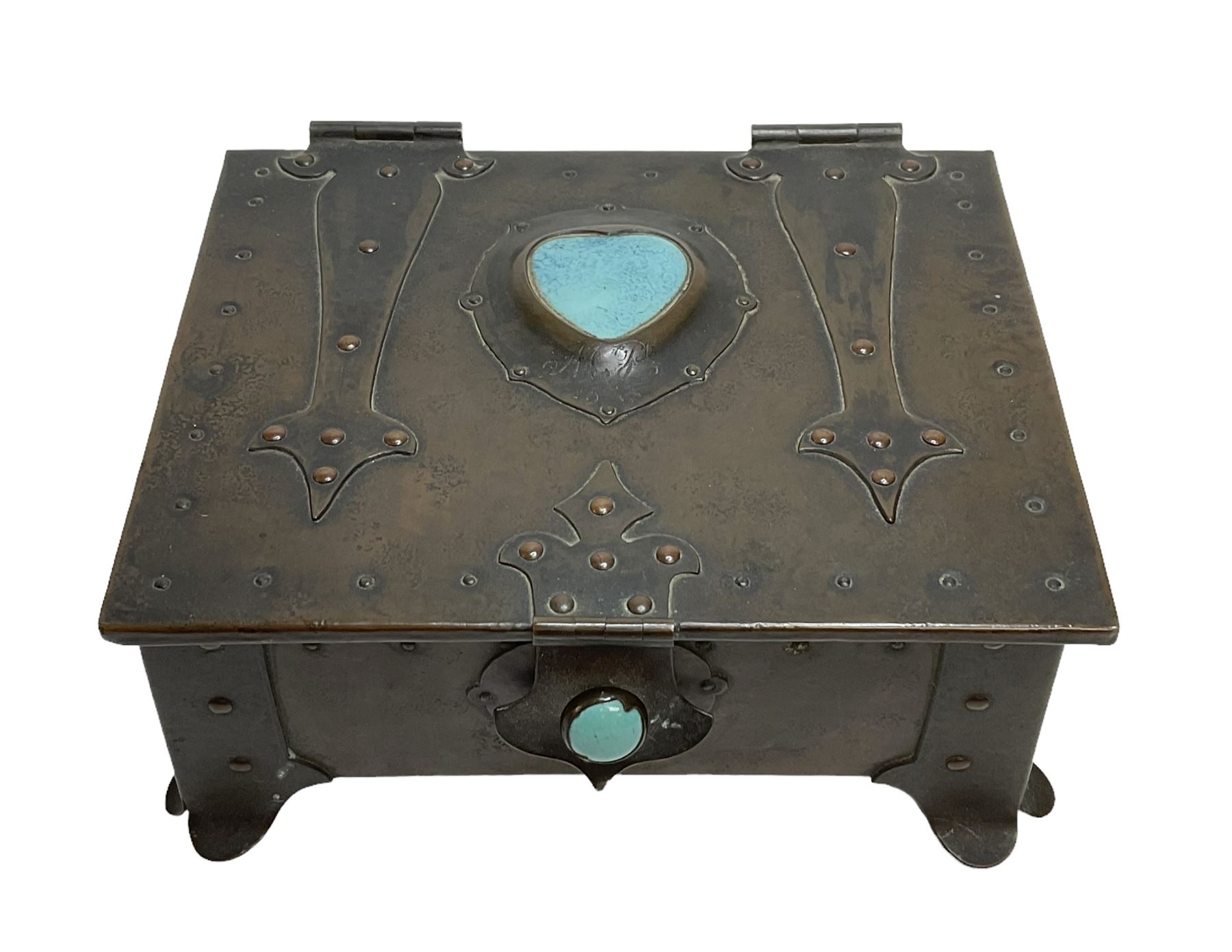 Arts and Crafts copper box, the lid decorated with stylised riveted hinges and inset with Ruskin type ceramic turquoise heart-shaped cabochon, the mount etched M.B 1913, and further cabochon roundel to each side panel, including one inset to the clasp acting as the knob to the locking mechanism, marked RS Douglas 1913 beneath, W16.5cm H7cm D15cm