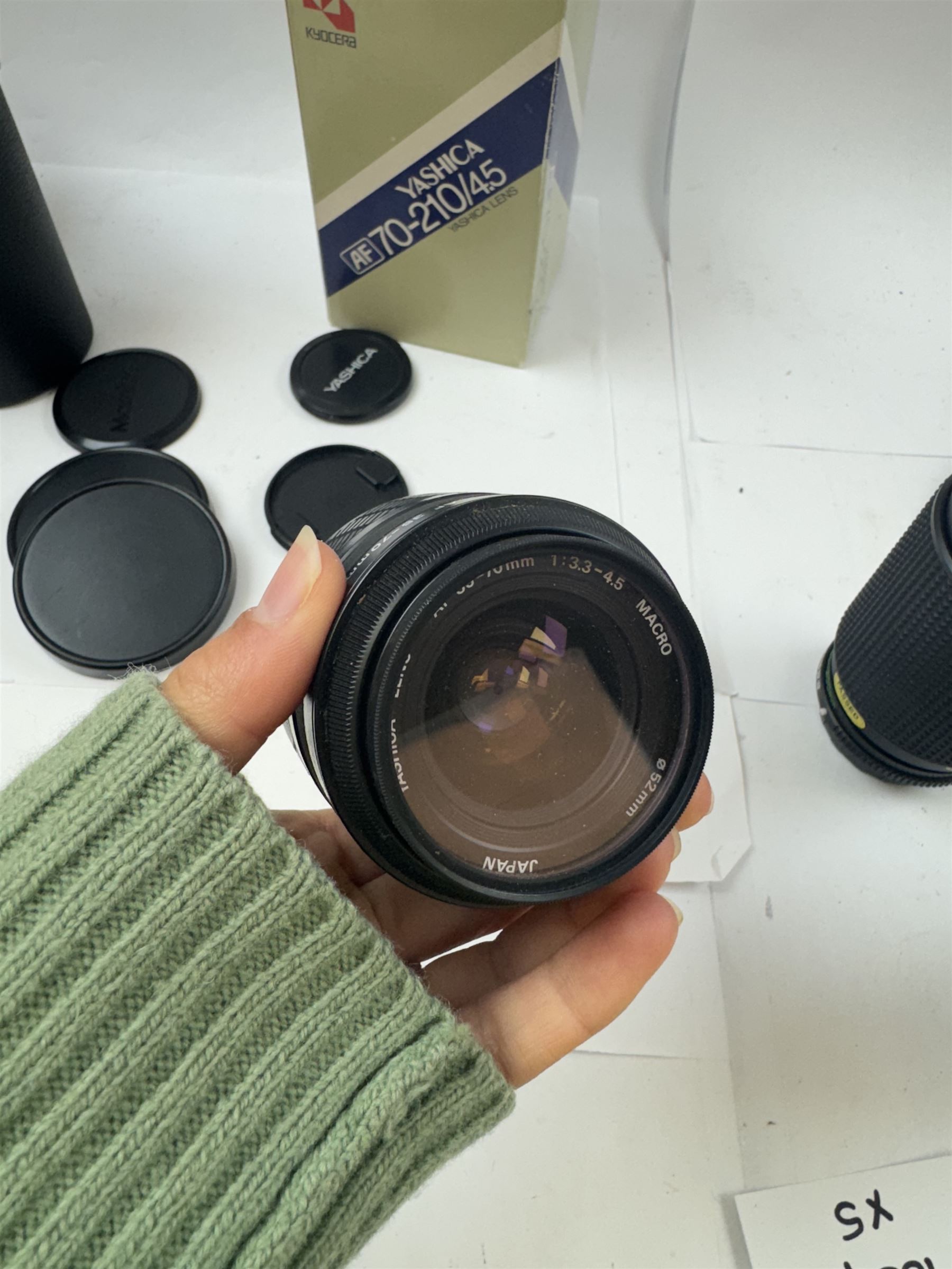 Group of camera lenses, comprising Yashica AF 70-210mm 1:4.5 58mm lens serial no. F6106983, boxed, Yashica AF 35-70mm 1:3.3-4.5 52mm Macro lens serial no. F60231147, Yashikor Aux Wide Angle 1:4 lens and a Yashikor Aux Tele-Photo 1:4 lens, Mamiya-Sekor E 1:2.8 f=28mm serial no. 13427 and a Mamiya-Sekor Zoom E 1:4 f=80-200mm lens serial no. 11271