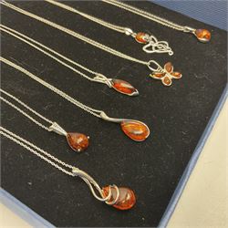 Seven silver Baltic amber pendant necklaces, including octopus and butterfly designs, all stamped 925 