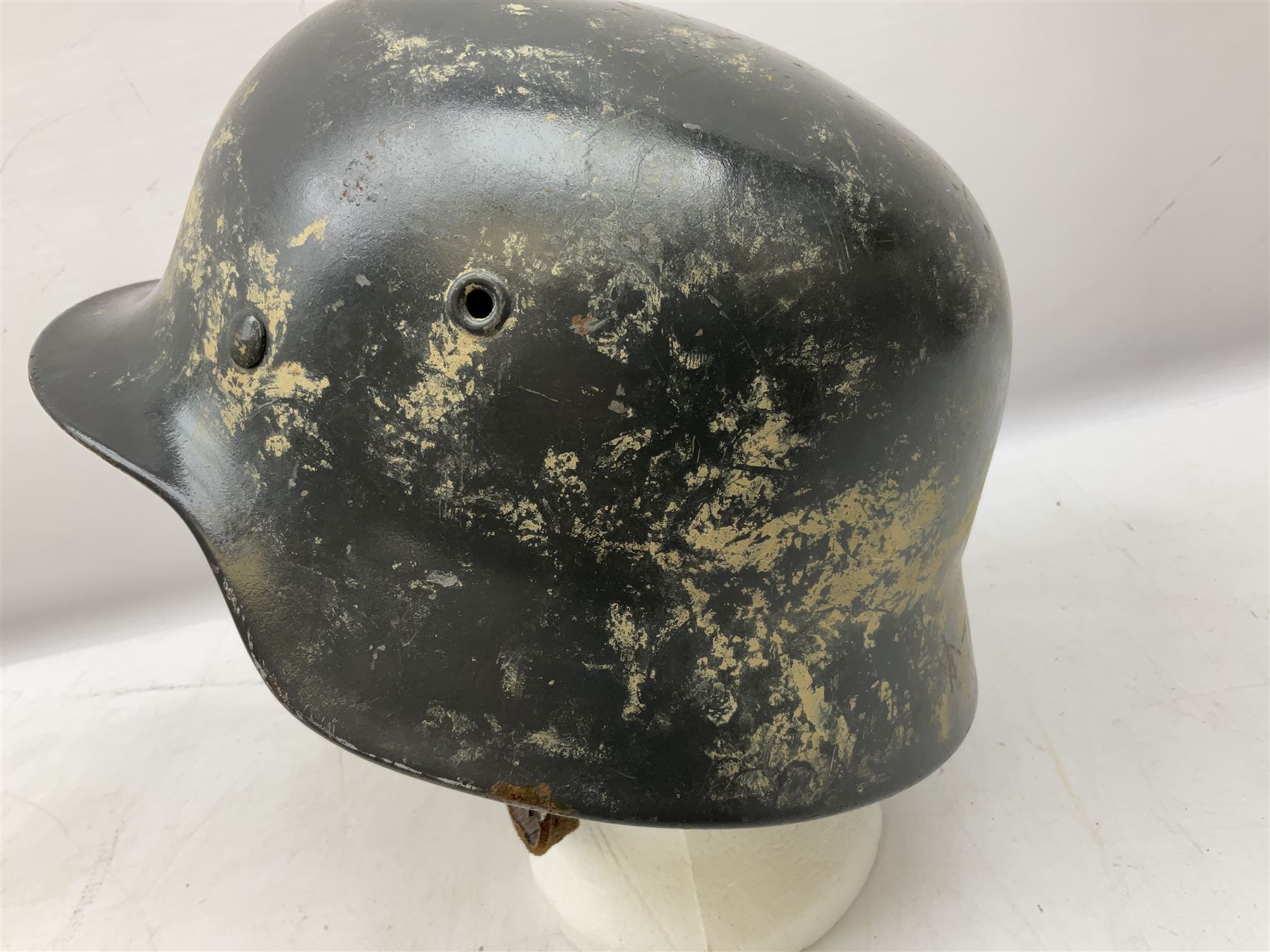 WW2 German steel helmet painted in undecaled Luftwaffe bluey grey with leather liner and chin strap stamped '58', the skirt impressed '1250'