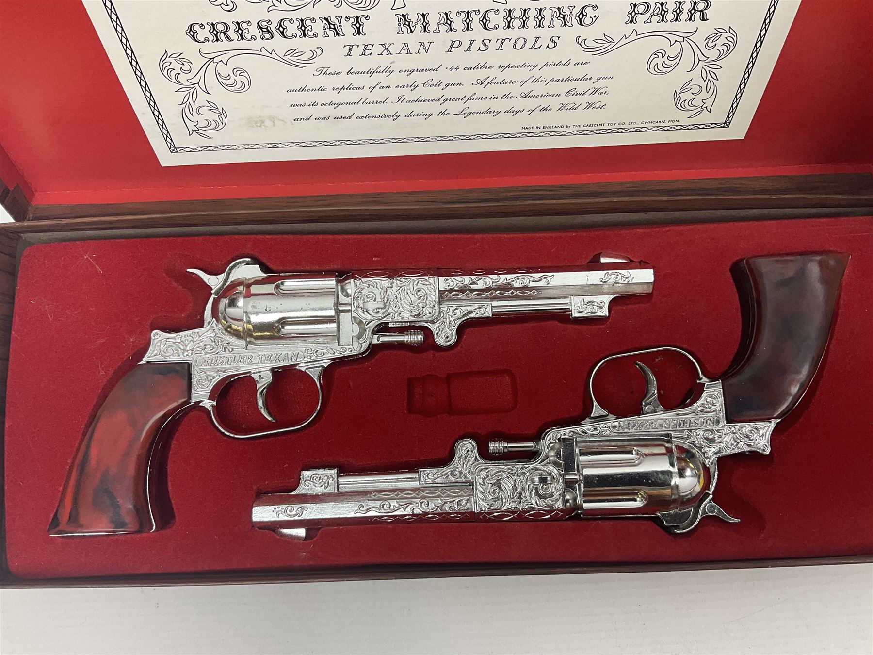 Crescent, Cap Guns - boxed 'Crescent Matching Pair' of 'Texan Pistols' toy cap guns; containing two ''Rustler Texan' ornately decorated pistols finished in silver / plated effect with brown marbled moulded grips; and Japanese Gakken Electronic Project Kit; boxed with wooden base and instruction booklet (2)