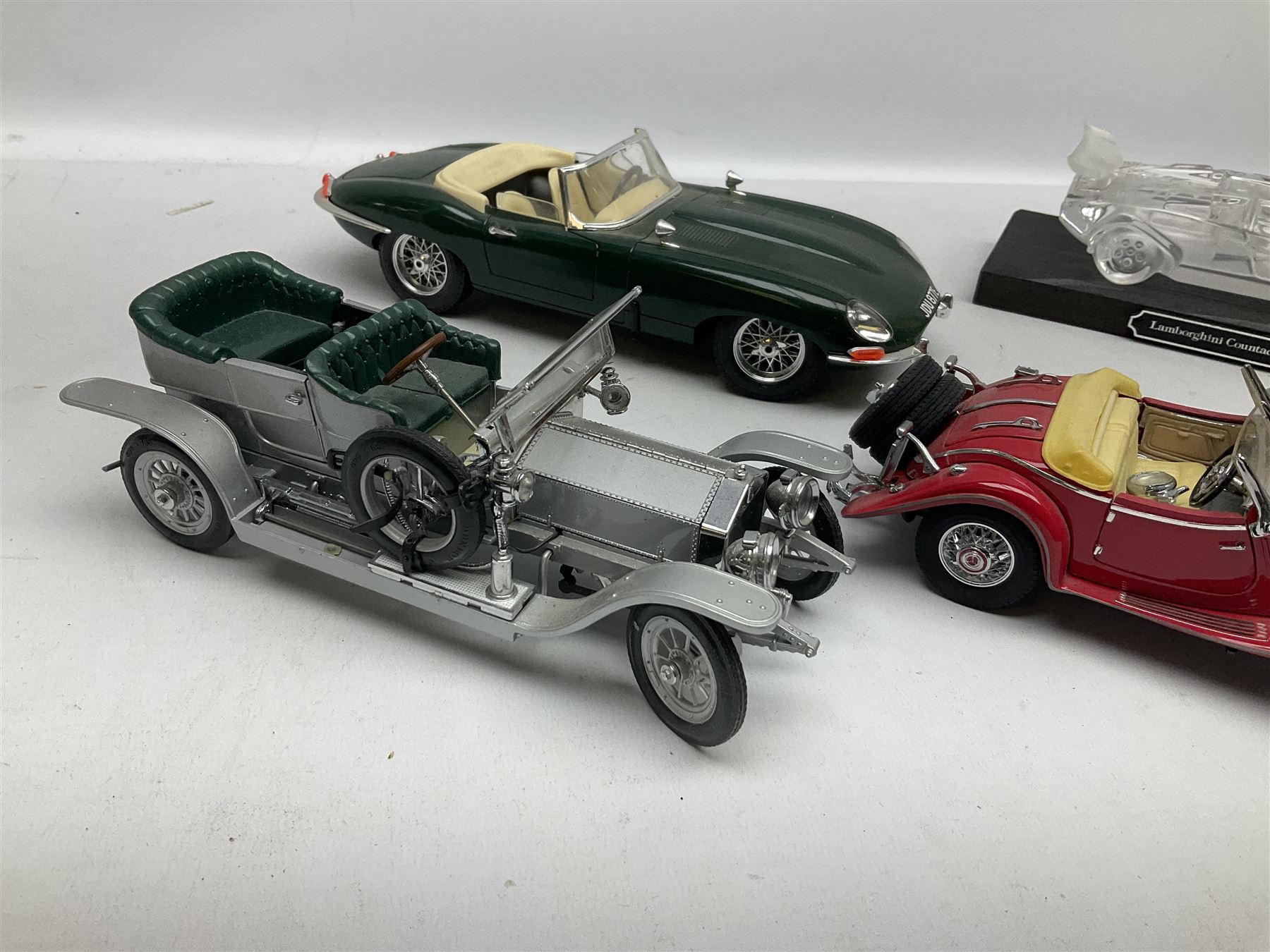 Three Franklin Mint die-cast models comprising 1935 Mercedes 500k Special Roadster, 1938 Jaguar SS-100 and 1907 Rolls Royce The Silver Ghost, together with Hof Bauer glass Lamborghini Countach
model and Bburago Jaguar 1961 'E' type