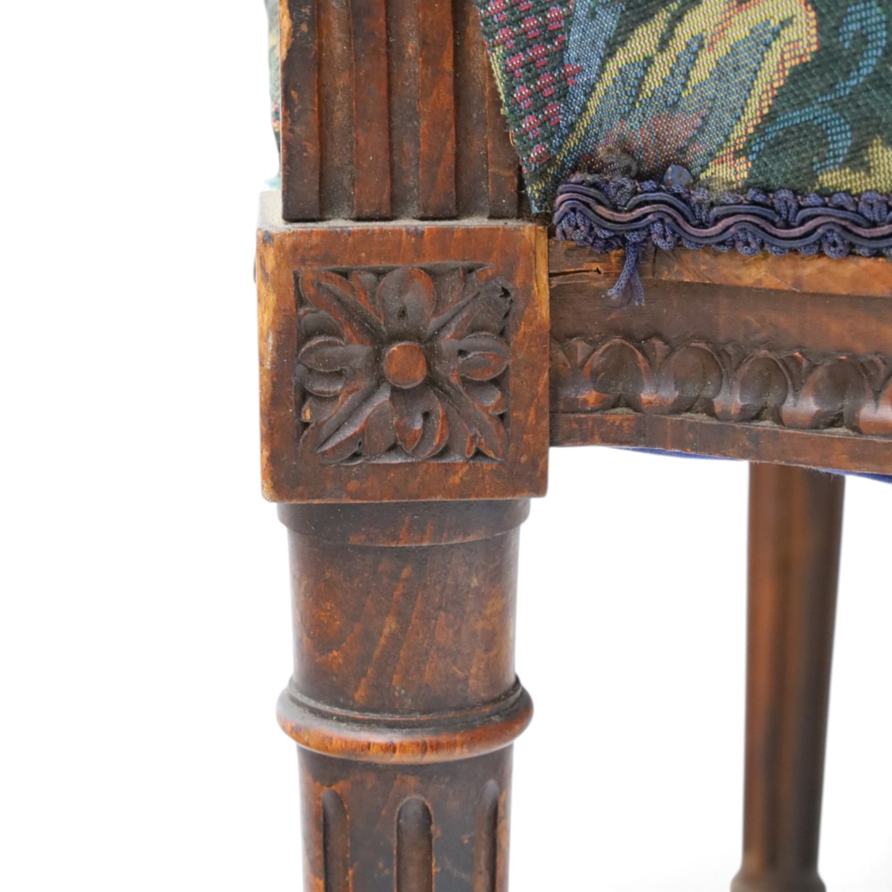 20th century French Louis XVI style stained beech two-seat salon settee, rectangular upholstered back and seat in floral tapestry fabric, carved and moulded frame with foliate cresting, padded open arms and fluted tapering supports