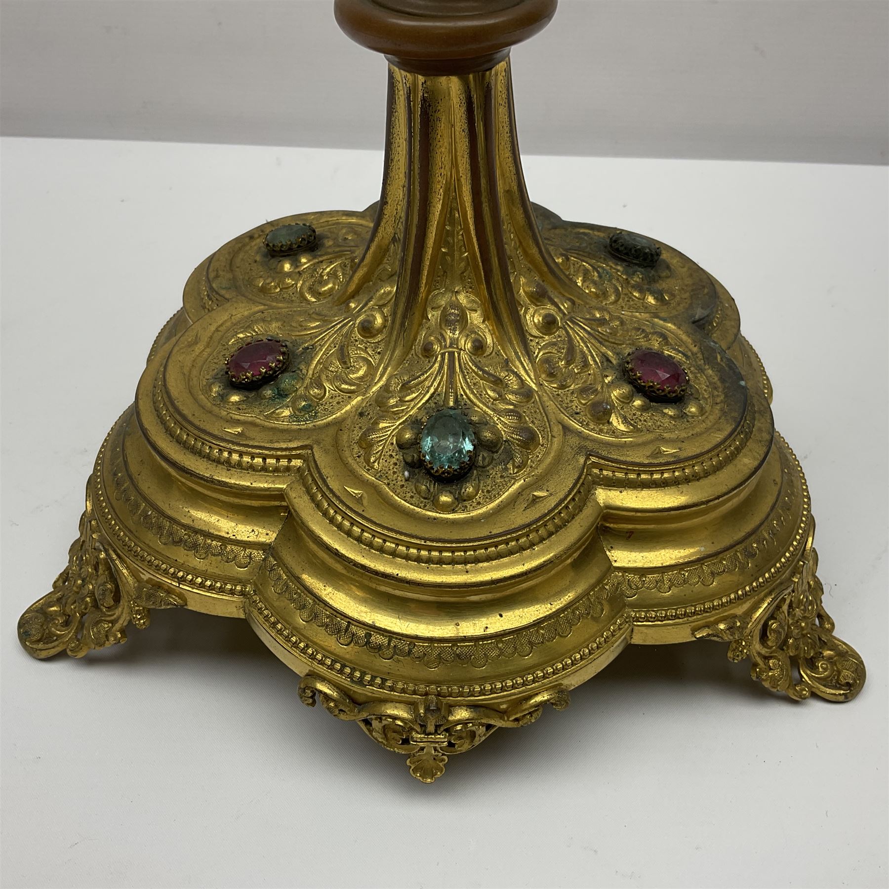 20th century gilt metal monstrance, in the Gothic revival style, with glazed aperture to centre surrounded with clear paste stones, in a pierced floral and scroll border set with coloured paste stones, within a sunburst surround, on a paste set knopped stem and similar foliate foot, H59.3cm