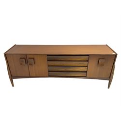 Elliots of Newbury (EoN) - mid-20th century teak sideboard, fitted with four central doors flanked by fall-front cupboard and a double cupboard, each with concave wooden handles