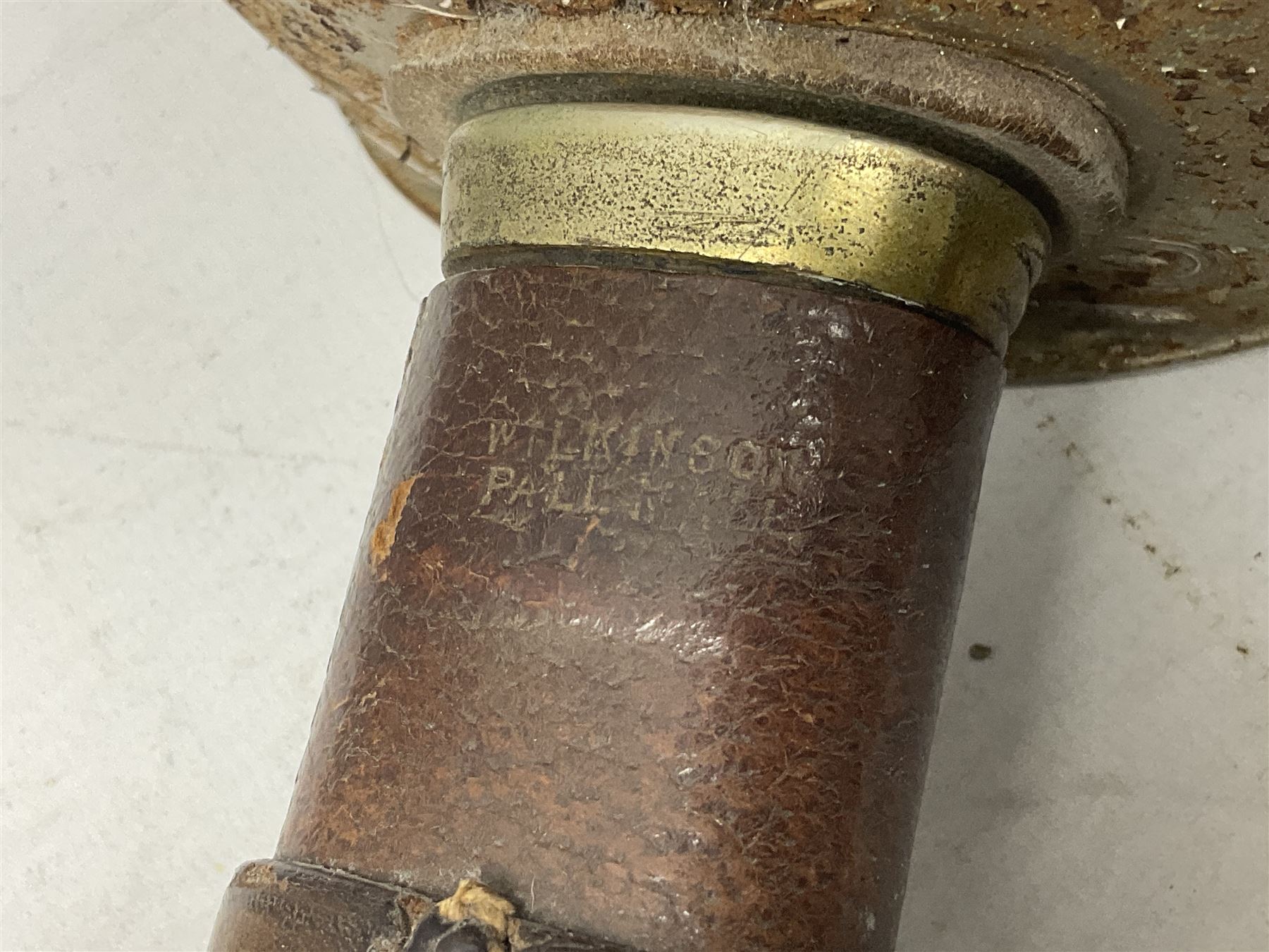 George V 1897 pattern Army Officer's sword by Henry Wilkinson Pall Mall London, the 82.5cm 'London Made' blade etched to both sides with Royal Crests and cyphers etc, pierced half-basket hilt with wire-bound fish skin grip and remains of leather knot strap; in leather covered field service scabbard L101cm overall; and two 14th Prince of Wales Own swagger sticks (3)