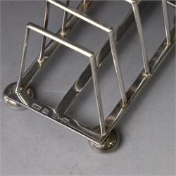 Victorian silver toast rack, with five angular bars and loop handle, upon four squat bun feet, hallmarked Thomas Hayes, Birmingham 1893, height including handle H10cm