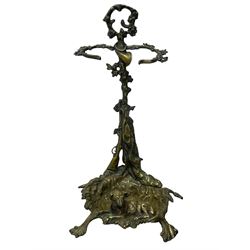 Pair of cast brass hallway umbrella or stick stands, in the form of a tree decorated with trailing flowering foliage branches, the stem with hunting horn over leaning shotgun, shaped naturalist tray base with hunting hound and out splayed foliate cast feet 