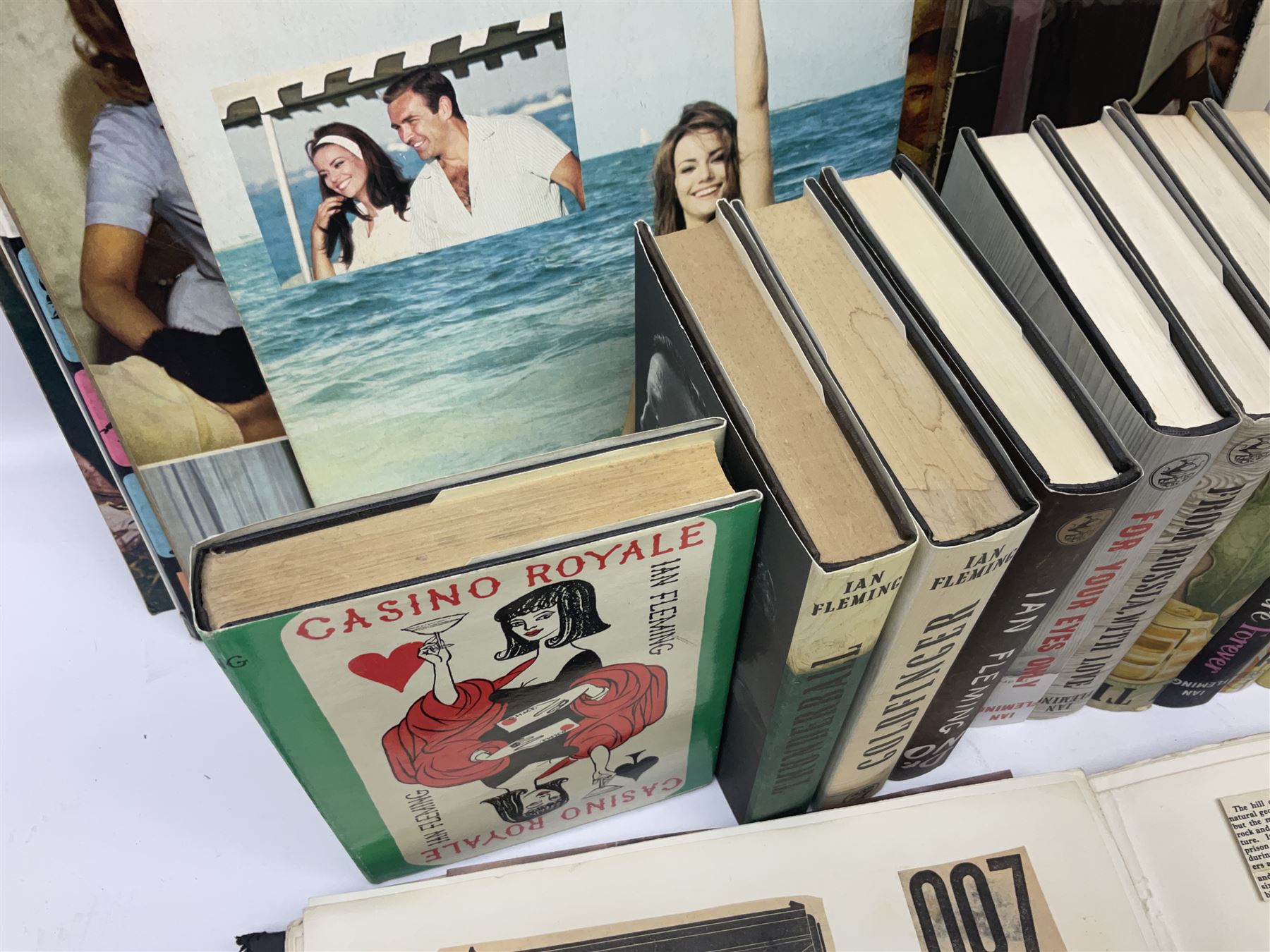 Sixteen James Bond books, including Live and Let Die, The Spy who Loved Me, Four Your Eyes Only, Moonraker etc, together with various 007 ephemera, soundtrack vinyls etc 