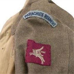 WWII British parachute regiment battle dress uniform, the jacket with shoulder title and Pegasus formation badge to the left arm, shoulder title, Pegasus formation badge and cloth wings to the right, size 3 dated 1943, the trousers size 3 dated 1945 