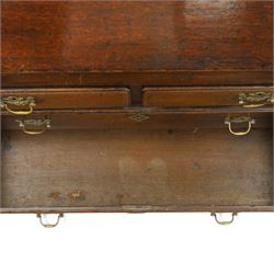 Georgian oak bureau, fall front with pierced brass escutcheon and handles, revealing a fitted interior, above two short over two long drawers, raised on bracket feet