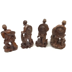Four Chinese carved wooden figures, modelled as fishermen with their catch, one modelled with birds at his feet, with inset eyes and teeth, approximately H20cm. 