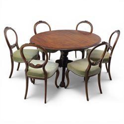 Victorian mahogany dining suite, oval tilt top dining table raised on a quatriform base with paw feet, together with a set of six balloon back dining chairs with green upholstery with cabriole legs 