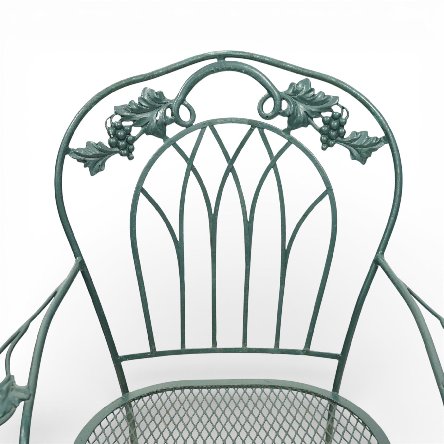 Green painted wrought metal garden table and chairs, with green striped cushions 