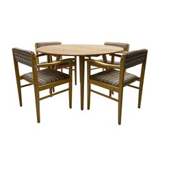 Ercol - elm and beech 'drop-leaf dining table', oval top raised on splayed tapering supports (W113cm D62cm H72cm); and set of four dining carver chairs, upholstered in textured striped fabric