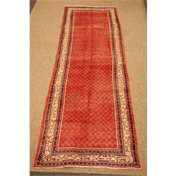  Araak red ground rug, field filled with boteh with a triple stripe geometric border, 315cm x 110cm  
