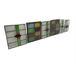Six leaded stained glass window panes, largest measuring - 46cm x 41cm